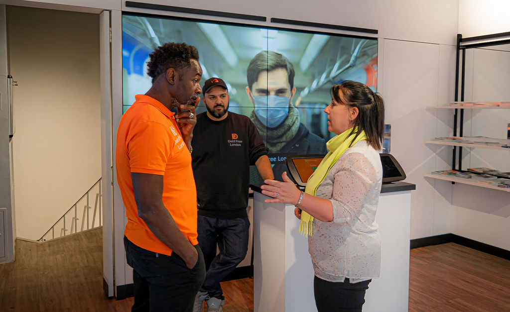 Advisor speaks with client in the Debt Free London Oxford Street pop-up location